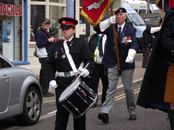 Photo:Heidi Watkins Drumming the parade back to the Island followed by Trevor Evans Standard Bearer for Canadian HQ Canadian Vets Assn. UK.