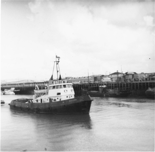 Photo:Meeching tug making her way down the harbour - c1961