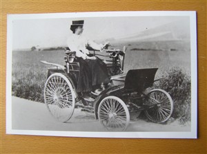 Photo:Winifred Turner seated upon an early model Benz