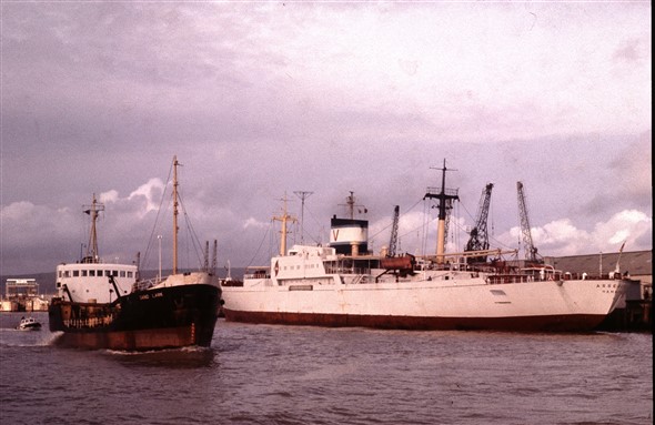 Photo:Sand Lark passing a Hamburg-registered cargo ship at the East Quay. Sand Lark was built in 1963 at 540 gross tons, re-named Sand Martin, and was eventually sold on for further service in West Africa.
