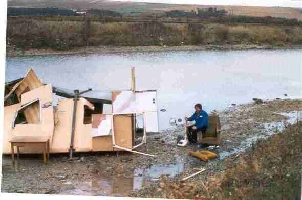 Photo:This picture shows my husband in his armchair still clutching his vacuum cleaner with his hut in pieces in the river.