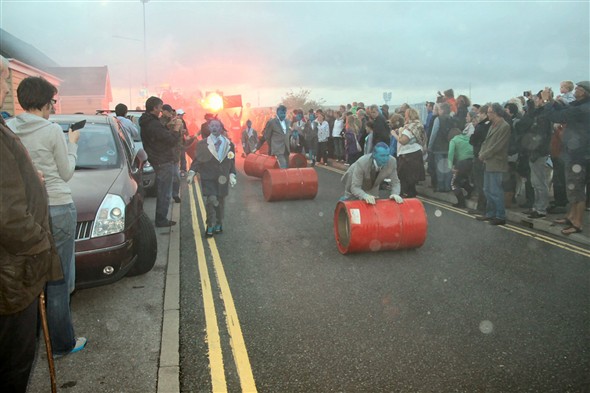 Photo:They rolled and banged the oil drums