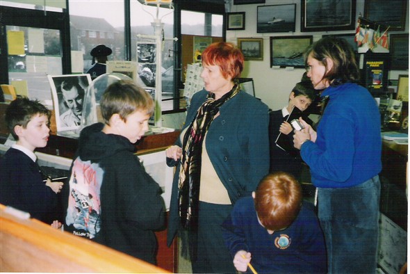 Photo:Paddy (Museum volunteer) and Jackie try and teach the children!