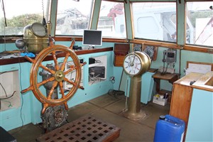 Photo:Starboard side of the wheelhouse, showing part of the new 'dashboard', including the radar screen. The ship's wheel and engine telegraphs are original.